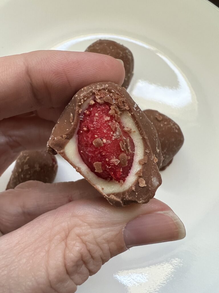 frozen strawberry covered in white and milk chocolate