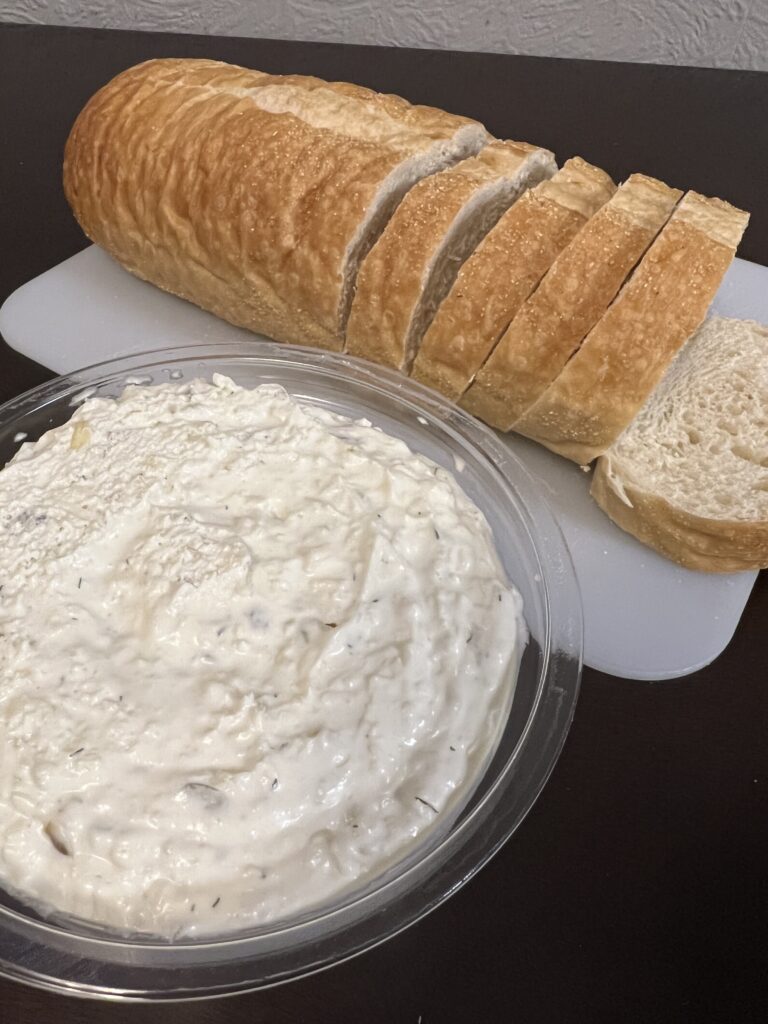 dip and loaf of sliced French bread