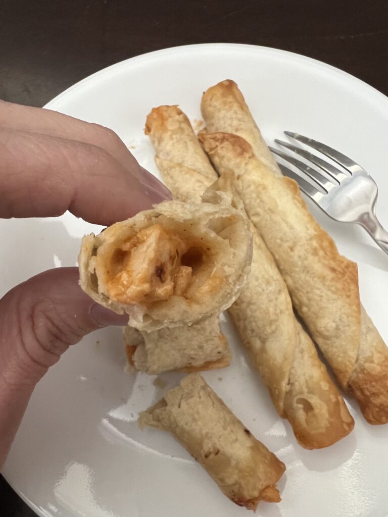 chicken and cheese filling inside taquito
