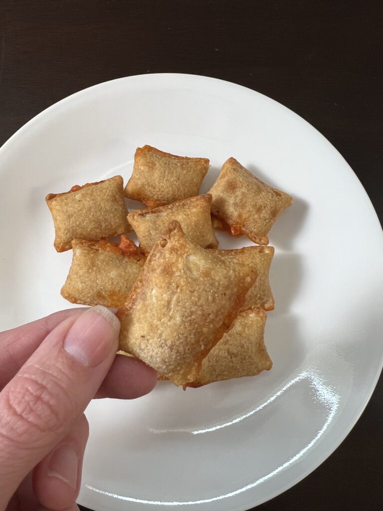 holding up a pizza roll
